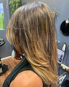 Sunkissed brunette hair in the salon, back view
