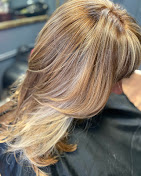 Long layered blonde hair, back view